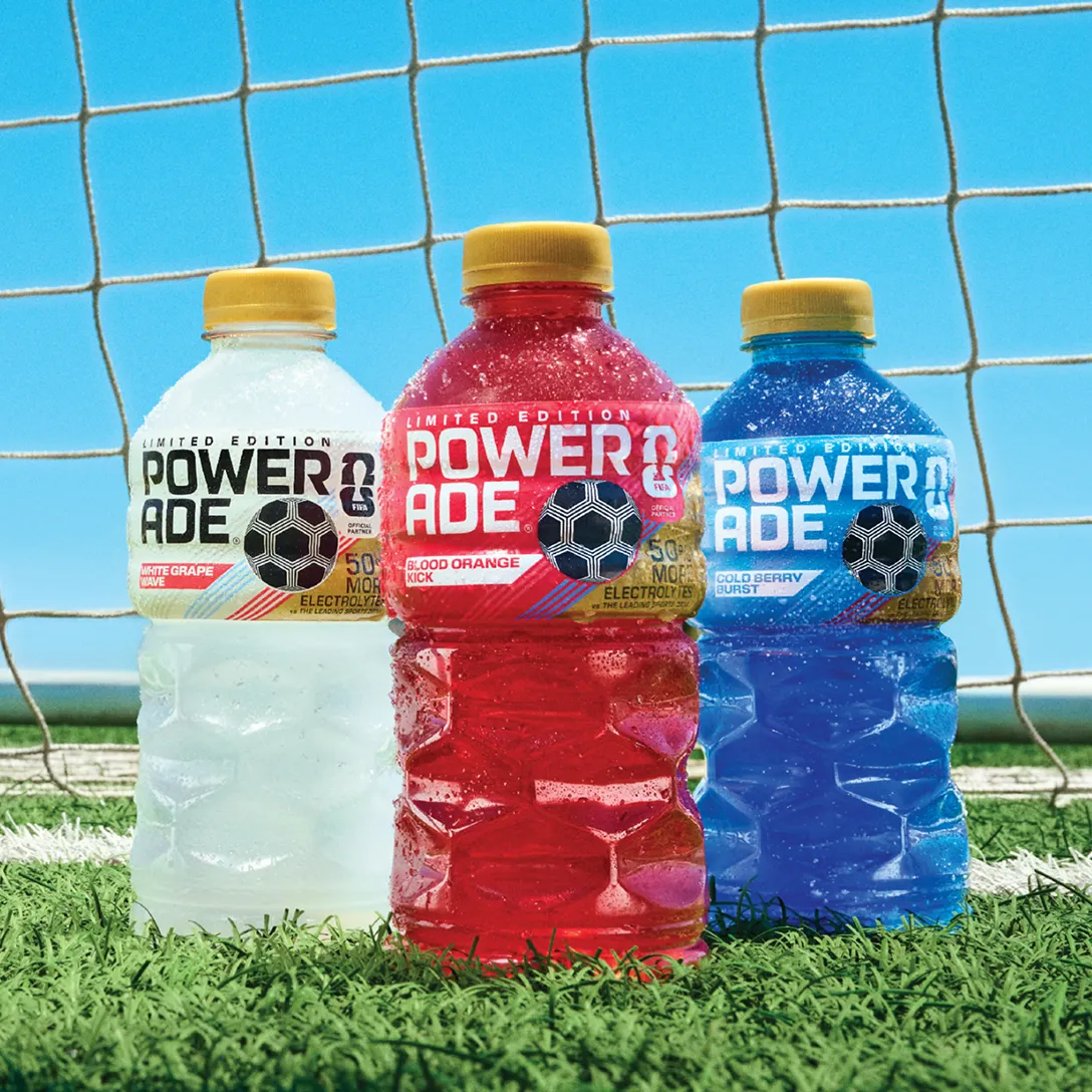 Three bottles of Powerade Legacy Lineup Drinks on a soccer field